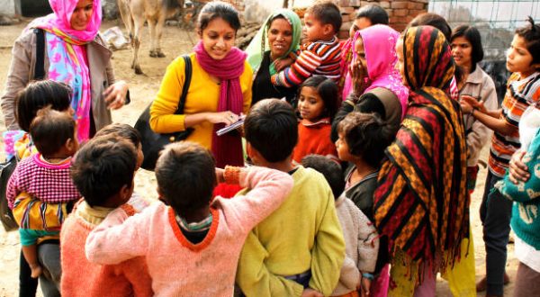 Ghaziabad, Uttar Pradesh, India- December 23, 2013: Two female social workers are interacting with a group of villagers comprising of children and female adults. They are working for the development of the village and uplifting the standard of living in the village.